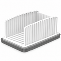 White manual bread slicing guide with one gray crumb tray on a white background