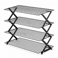 Black four-tier collapsible wire cooling rack on white