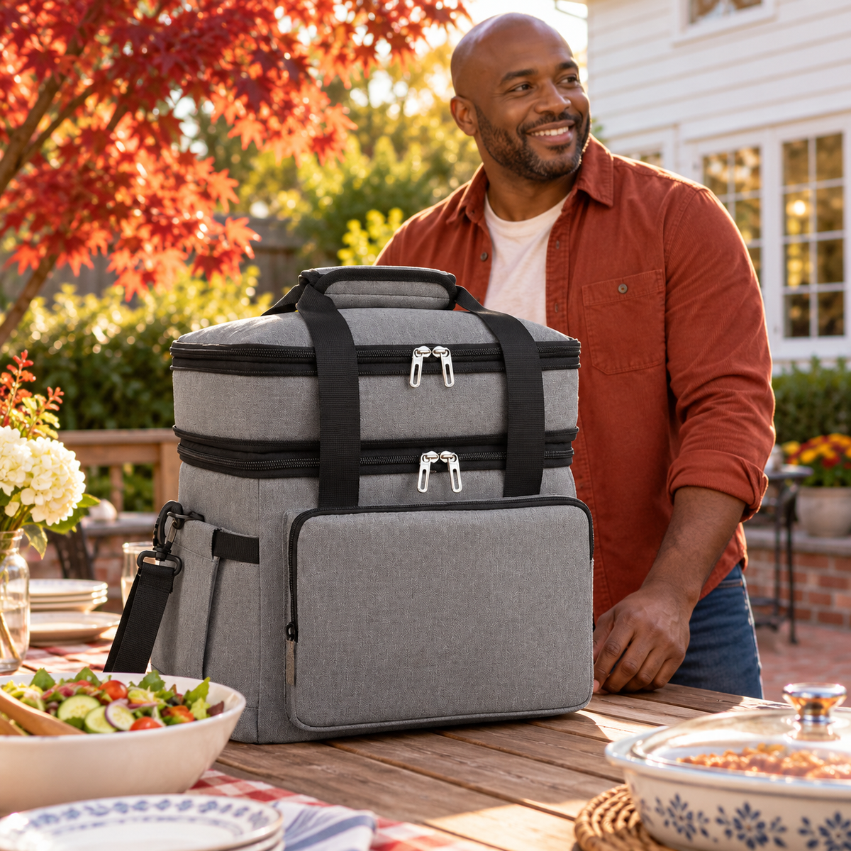 Gray food carry bag at a backyard potluck preparation table